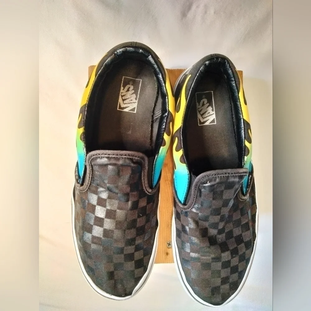Vans slip on shoe. Size 7. Black  with blue/green and yellow🔥 running down side